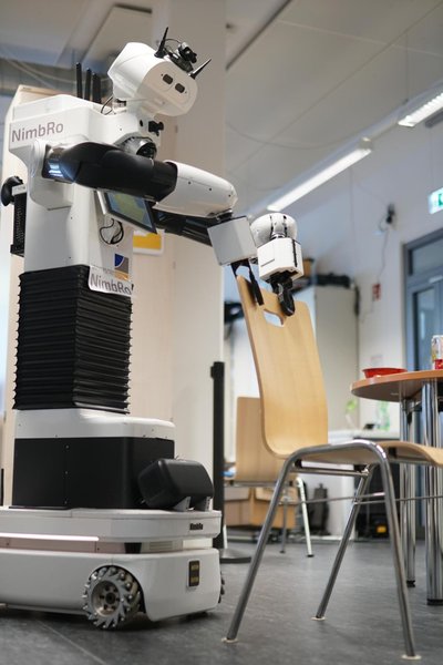 Tidying up: robot pushing a chair